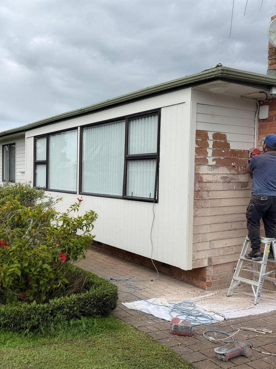 Exterior surface preparation underway with ground and gardens protected