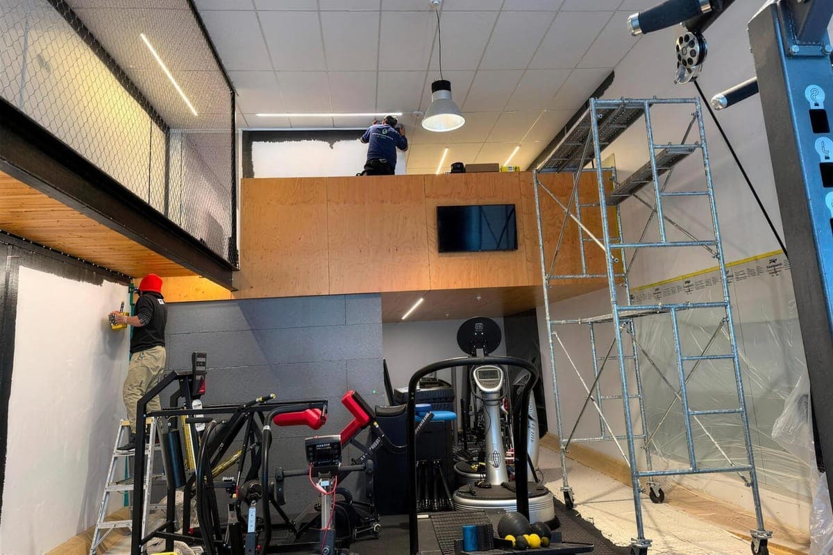 Commercial gym interior being repainted by EGP Decorator Limited with equipment protected under drop sheets